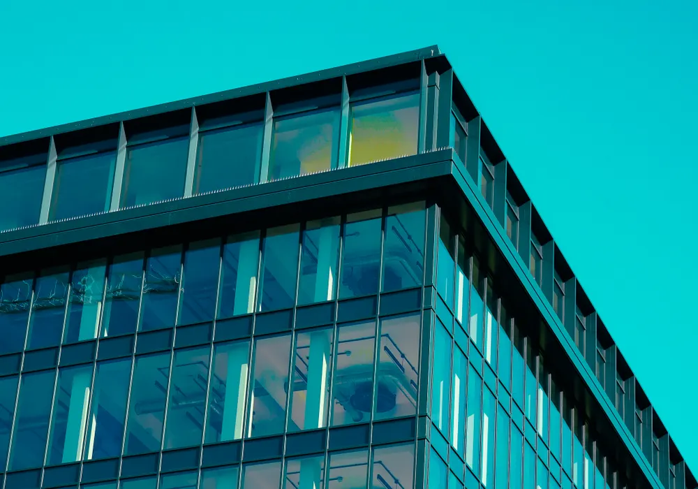 Glass office architecture viewed against a blue sky
